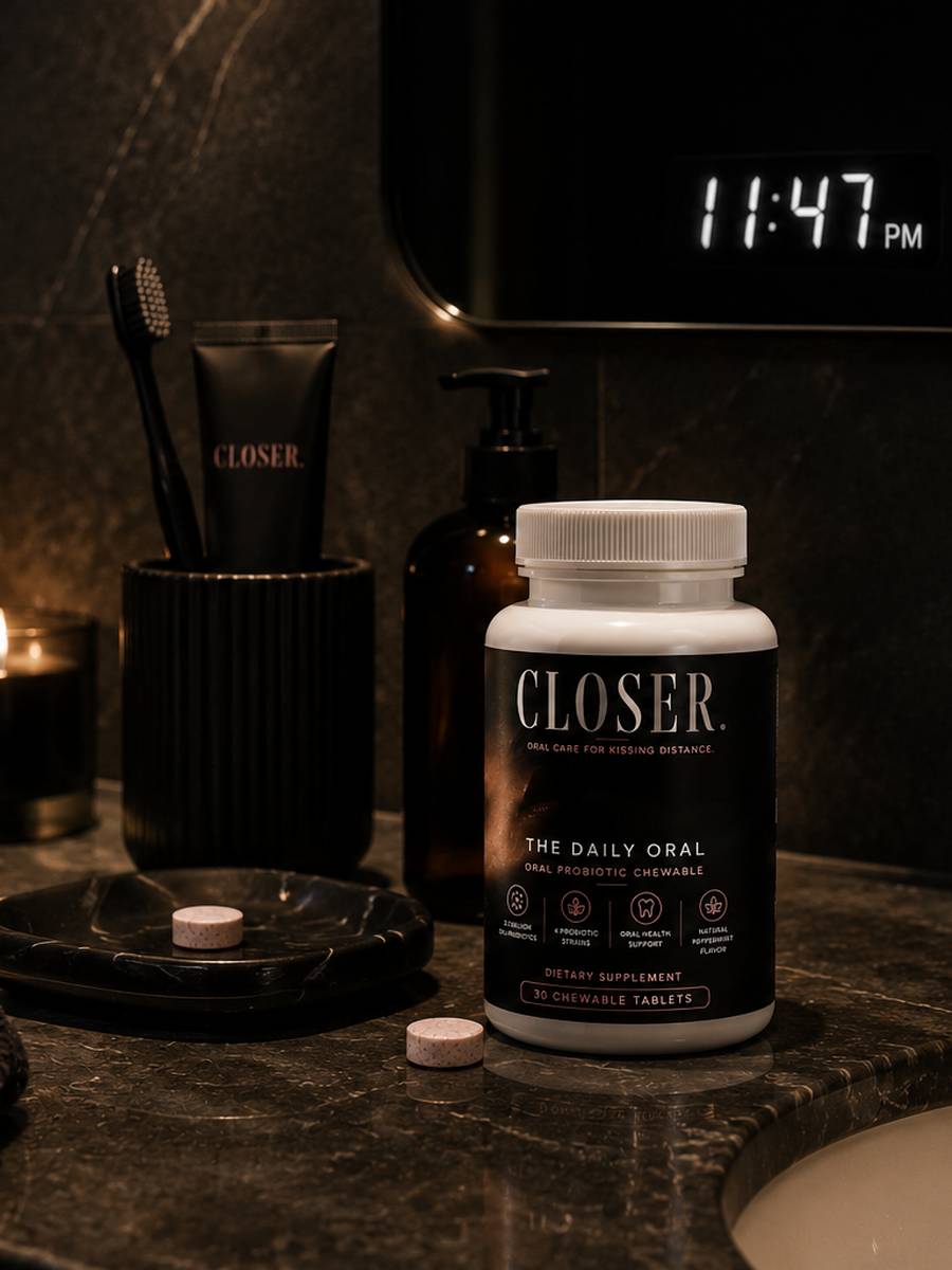 CLOSER. bottle on a luxury bathroom counter late at night